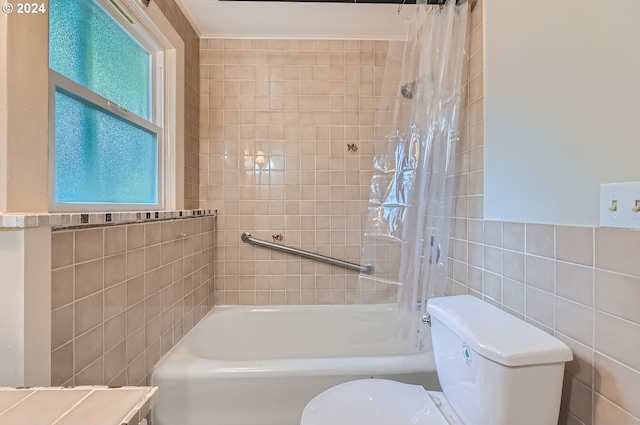 bathroom featuring shower / bath combo, toilet, and plenty of natural light