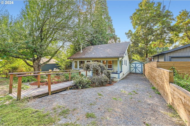 view of front facade with a garage, an outdoor structure, and a deck