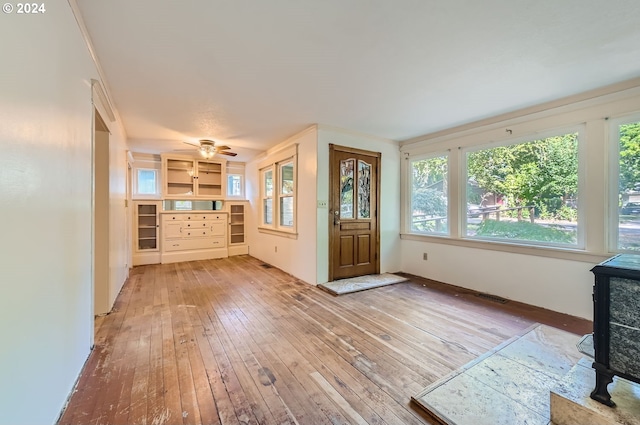 foyer entrance with ceiling fan and hardwood / wood-style floors