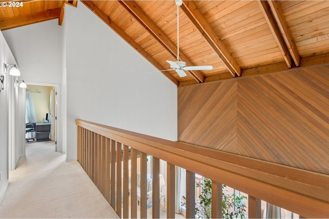 hallway with carpet, high vaulted ceiling, beam ceiling, wooden walls, and wooden ceiling