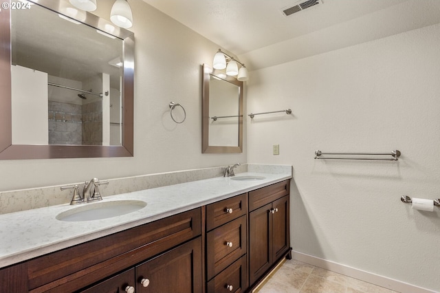 bathroom featuring tile flooring, oversized vanity, and double sink