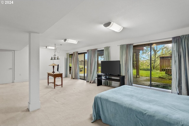 bedroom featuring light colored carpet and multiple windows