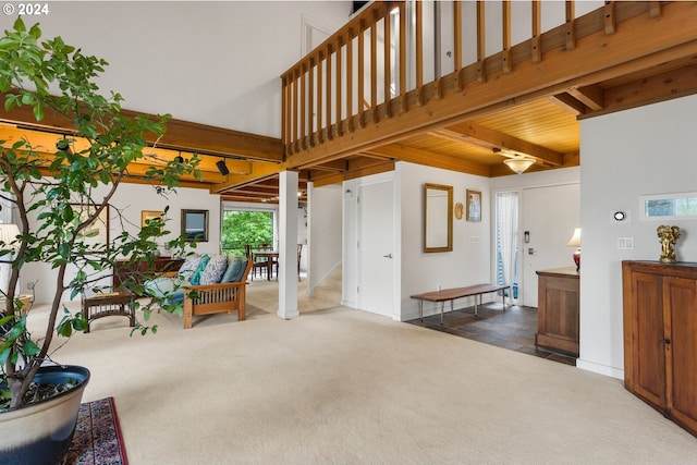 interior space featuring carpet flooring and beamed ceiling