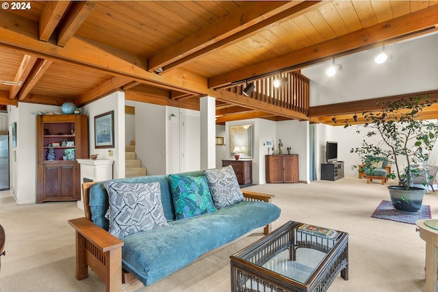 carpeted living room with rail lighting, beam ceiling, and wooden ceiling