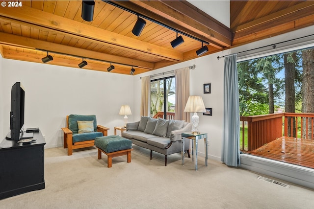 living room featuring wood ceiling, beamed ceiling, and carpet floors