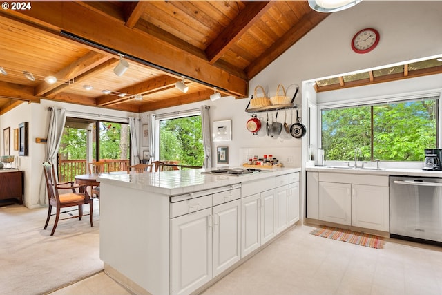 kitchen with appliances with stainless steel finishes, wooden ceiling, plenty of natural light, and white cabinetry