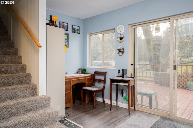 living area with wood-type flooring and a textured ceiling