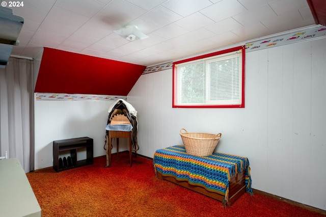 bedroom with carpet floors and lofted ceiling