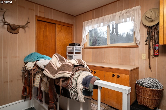 miscellaneous room featuring wood walls