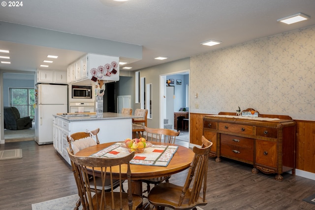 22726 Cedar Grove Rd, Clatskanie, OR 97016 - dining room with wallpapered walls, dark wood-style floors, and wainscoting