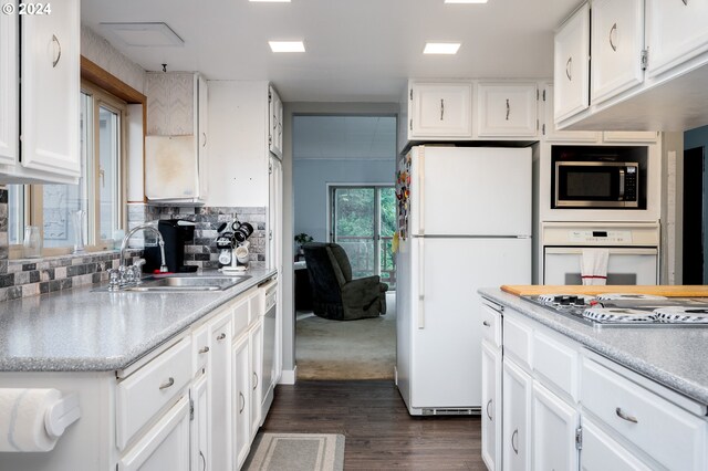 22726 Cedar Grove Rd, Clatskanie, OR 97016 - kitchen featuring white appliances, dark wood-style floors, light countertops, white cabinets, and backsplash