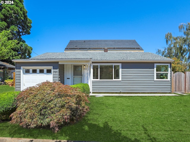 view of front facade with a front yard and a garage