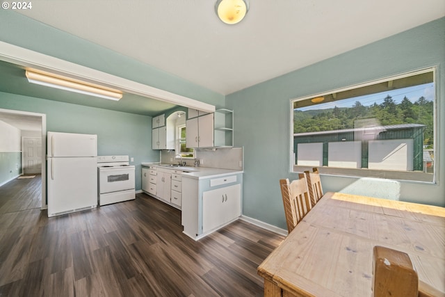 kitchen featuring white appliances, dark hardwood / wood-style floors, sink, and white cabinets