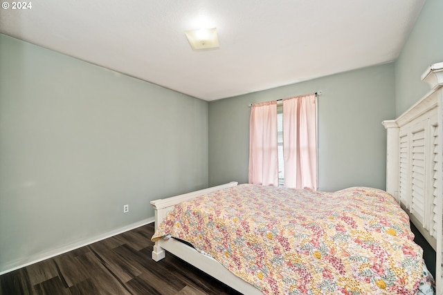 bedroom featuring dark hardwood / wood-style flooring