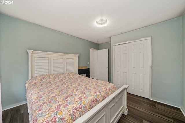 bedroom with a closet and dark wood-type flooring