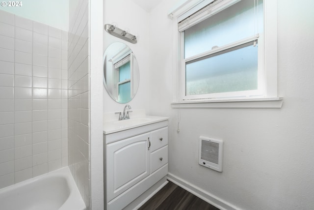 bathroom featuring a bathing tub, vanity, and hardwood / wood-style floors