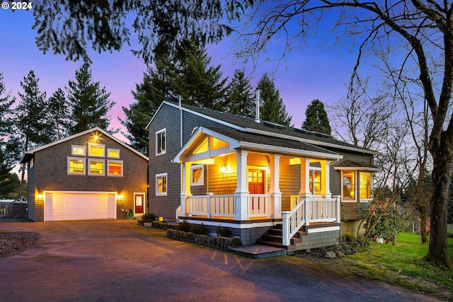 view of front of house featuring a garage and a porch