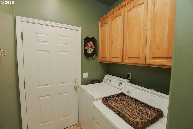 washroom with cabinets and washer and clothes dryer