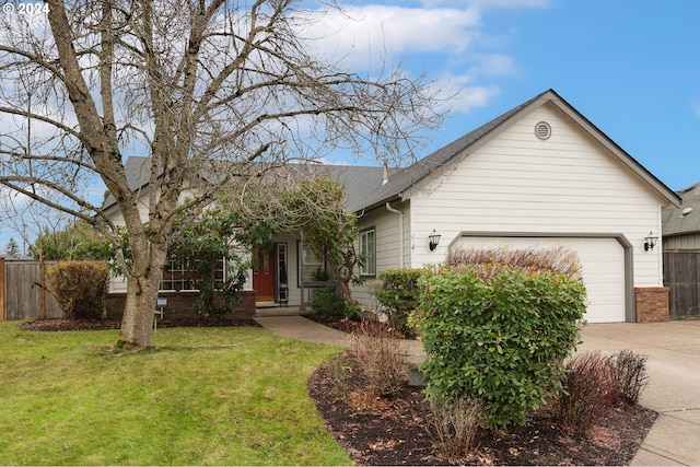 view of front of property featuring a garage and a front lawn