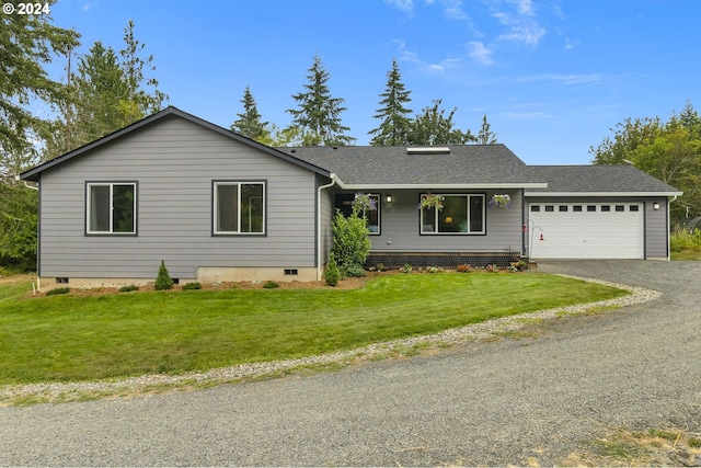 ranch-style home featuring a garage and a front lawn