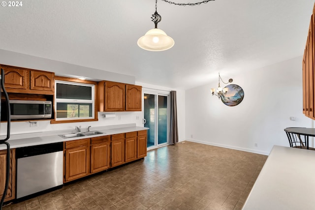 kitchen featuring an inviting chandelier, sink, hanging light fixtures, and stainless steel appliances