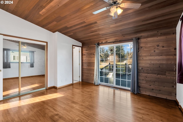 unfurnished room with a healthy amount of sunlight, wooden ceiling, and vaulted ceiling