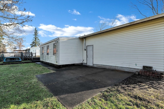 exterior space featuring a deck, a patio, and a yard