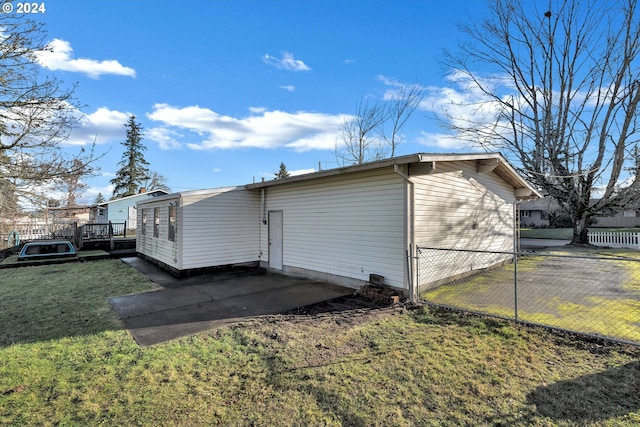 rear view of property featuring a yard and a deck