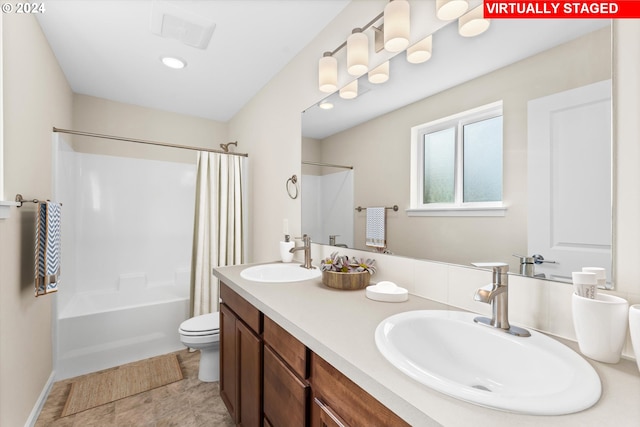 full bathroom featuring shower / bath combination with curtain, vanity, and toilet