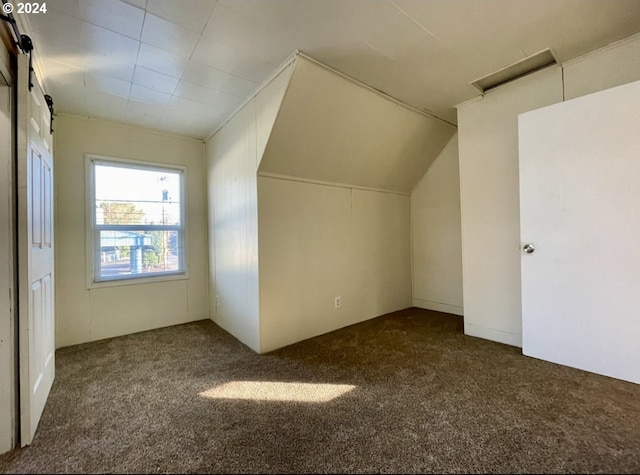 bonus room featuring dark carpet and lofted ceiling