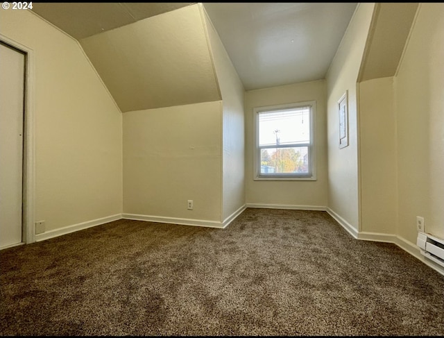 additional living space with carpet flooring, a baseboard radiator, and lofted ceiling