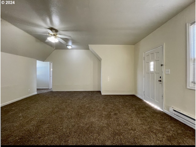 bonus room with dark carpet, baseboard heating, vaulted ceiling, and ceiling fan