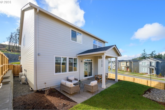 rear view of property featuring a yard and a patio area