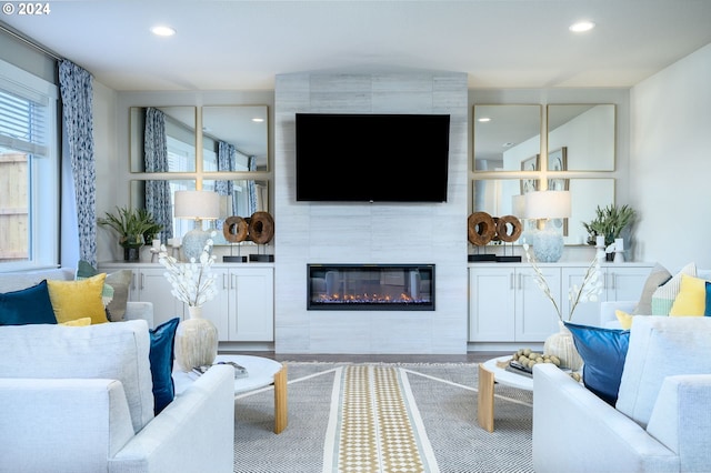 living room featuring a tile fireplace