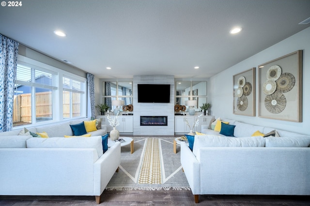 living room featuring dark hardwood / wood-style floors and a fireplace