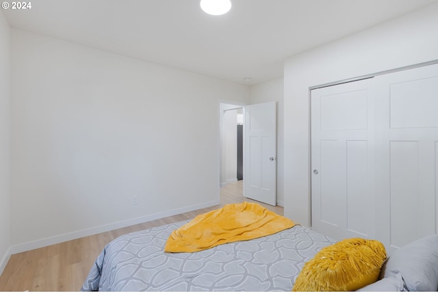 bedroom featuring a closet and light wood-type flooring