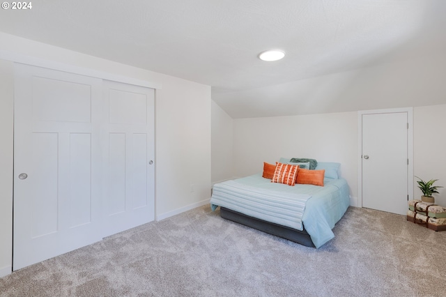 carpeted bedroom featuring lofted ceiling