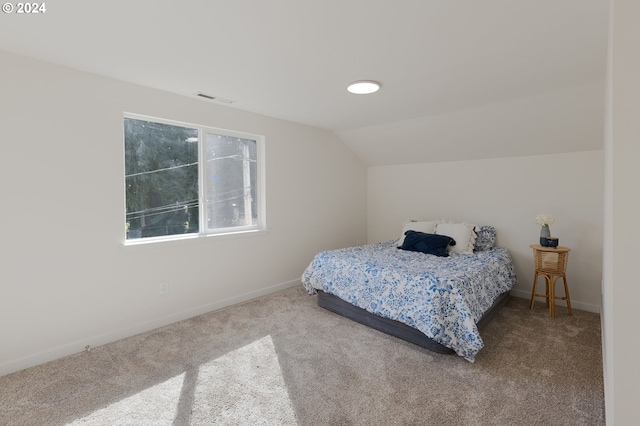 bedroom with vaulted ceiling and carpet