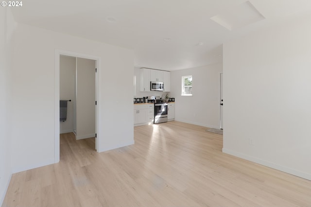 spare room featuring light hardwood / wood-style floors