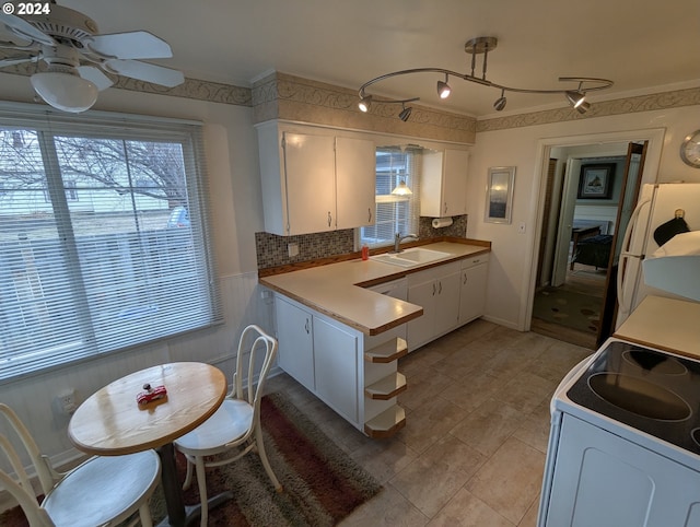 kitchen with white cabinetry, sink, ceiling fan, decorative light fixtures, and white appliances