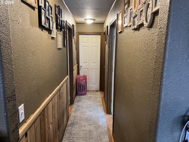 corridor with a textured ceiling