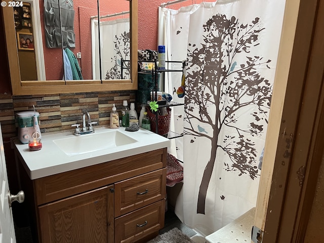 bathroom featuring vanity and tasteful backsplash