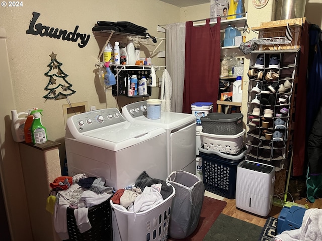 laundry area featuring hookup for a washing machine, separate washer and dryer, and wood-type flooring