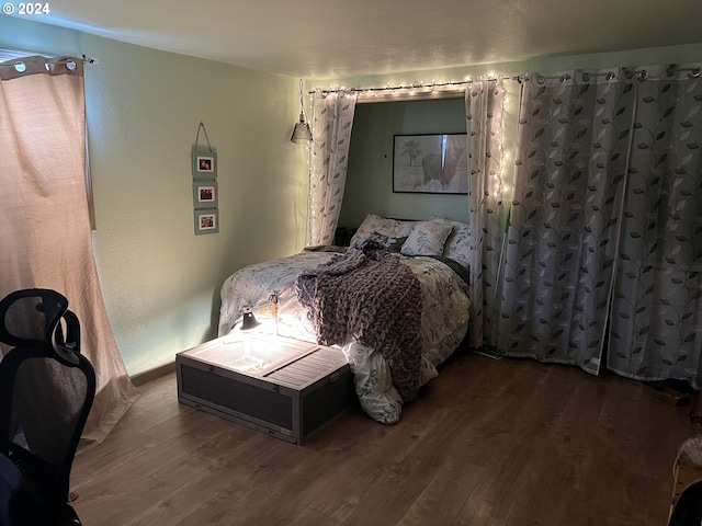 bedroom with dark hardwood / wood-style floors