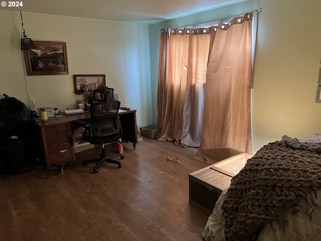 bedroom with dark wood-type flooring