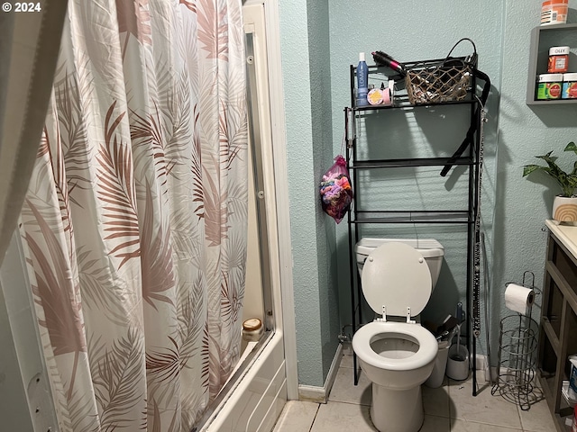 full bathroom featuring toilet, tile floors, vanity, and shower / bath combo with shower curtain