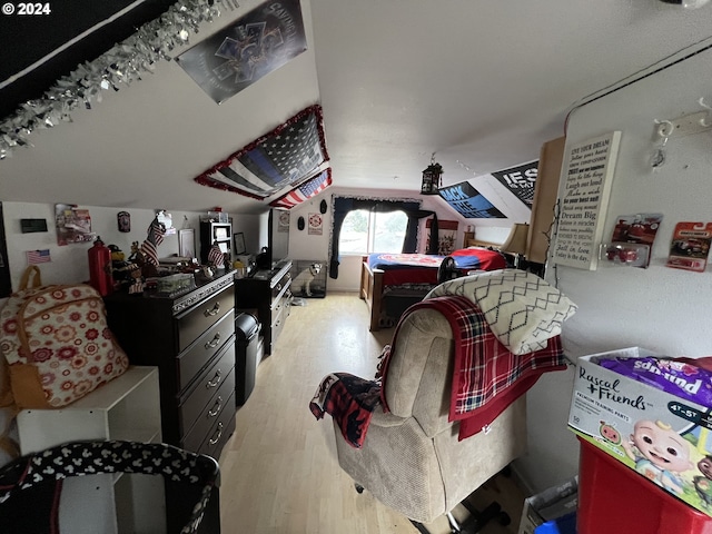 bedroom featuring lofted ceiling and light hardwood / wood-style floors