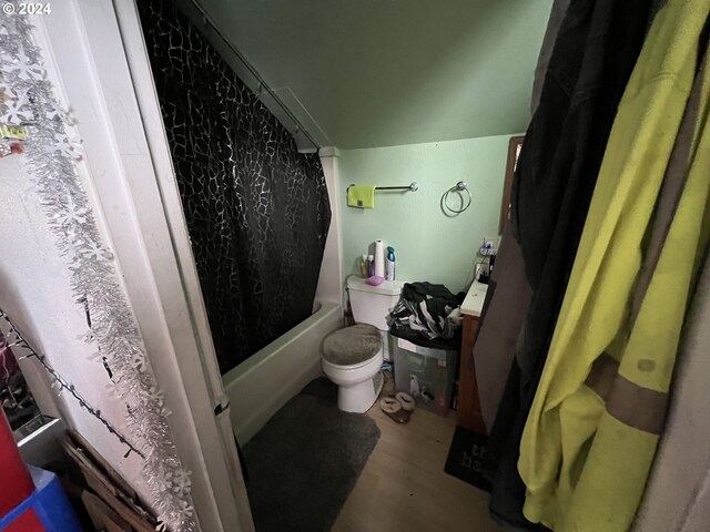 full bathroom with toilet, wood-type flooring, vanity, and shower / bath combo with shower curtain