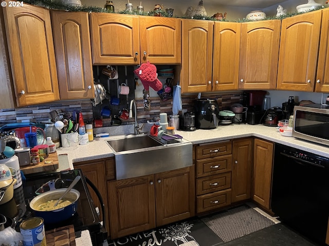 kitchen featuring sink, dishwasher, backsplash, range, and tile floors