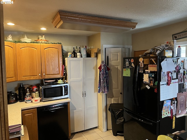 kitchen featuring a textured ceiling, light tile flooring, and black appliances